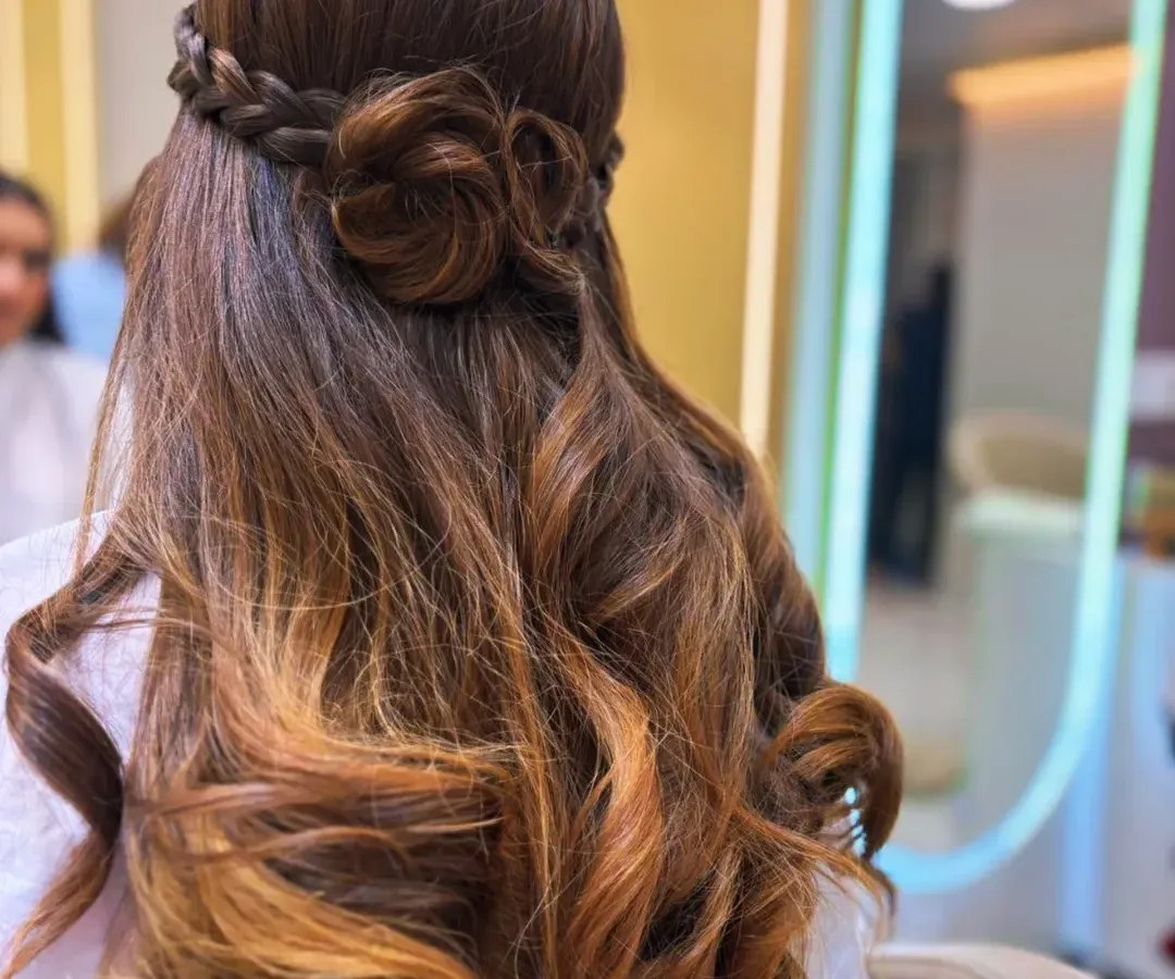 A hairstyle that's pure art. We created this beautiful look by combining a soft balayage for dimension with an intricate rose braid, perfect for a special occasion or when you just want to feel amazing.