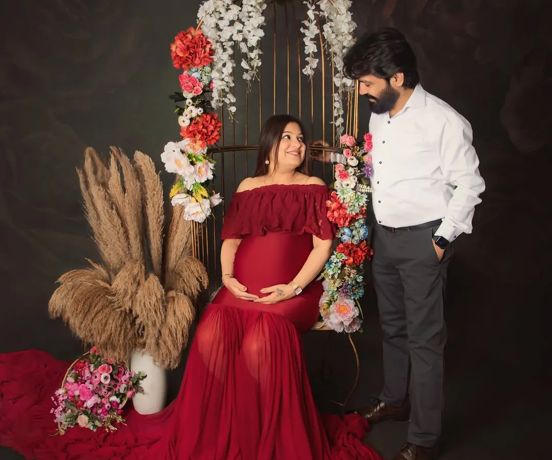 Feeling like a goddess in red. This maternity session was all about celebrating the power and beauty of motherhood with a stunning floral birdcage prop and a flowing gown to highlight the beautiful baby bump.