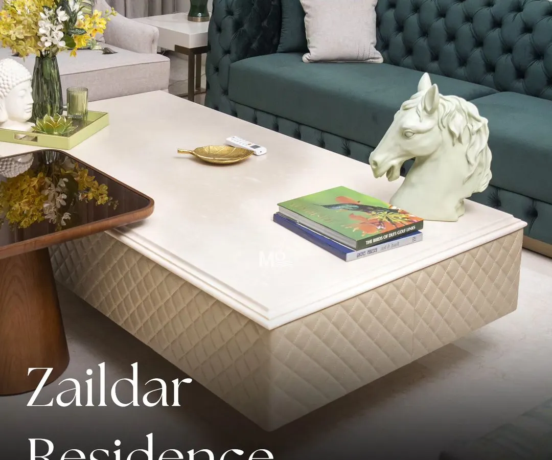 We believe a living room should be a statement of comfort. For the Zaildar Residence, we centered the design around this deep green velvet Chesterfield sofa, a timeless piece that exudes elegance. The entire space is a play on rich textures and a refreshing, nature-inspired color palette.