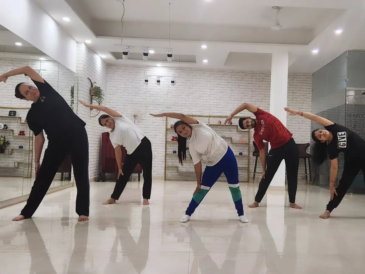 This is from one of my group yoga classes at The Marun Dance Studio in Dwarka. I'm guiding my students through a side-stretching sequence to improve flexibility and release tension.