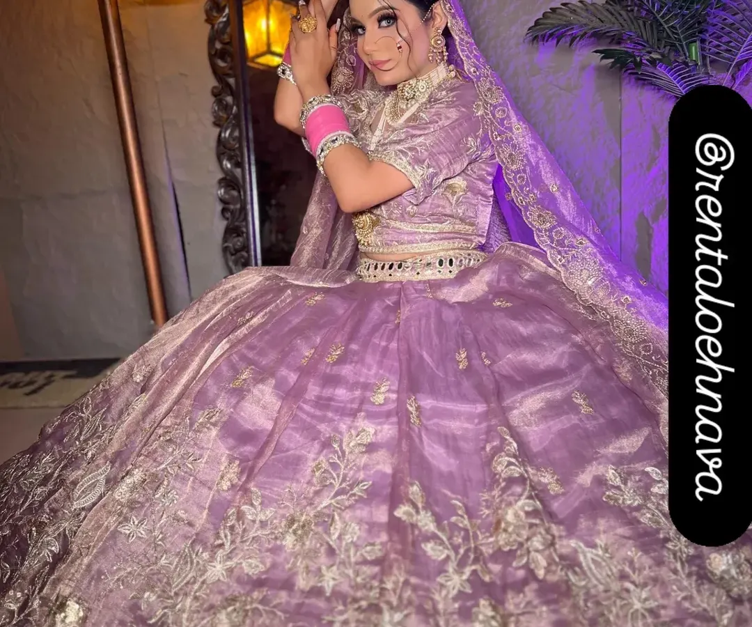 For the modern bride, I offer pastel options like this beautiful lilac organza lehenga. It's detailed with delicate silver floral embroidery, ideal for a day wedding or Anand Karaj ceremony.