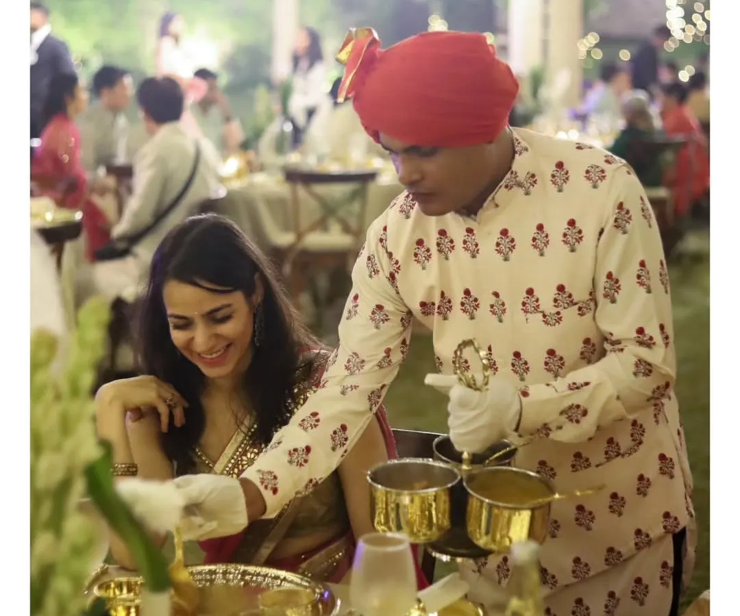 Our service is defined by grace and attention to detail. Here, a member of our professionally trained staff, attired in traditional uniform, provides personal table service at an elegant sit-down dinner, ensuring every guest feels exceptionally cared for.