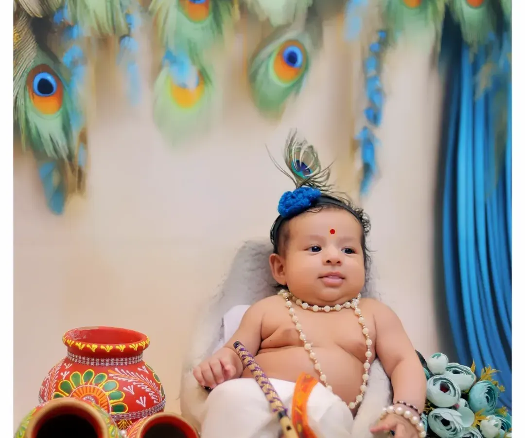 One of my most requested themed photoshoots, this Little Krishna setup features a custom costume, peacock feather backdrop, and traditional props like painted matkas.