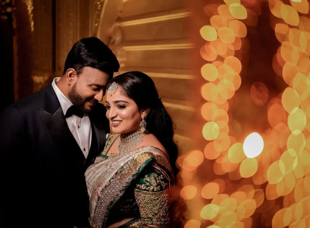 A quiet moment for the couple amidst the grand reception. We love using creative lighting like this beautiful bokeh effect to create romantic, artistic portraits that feel both intimate and grand.