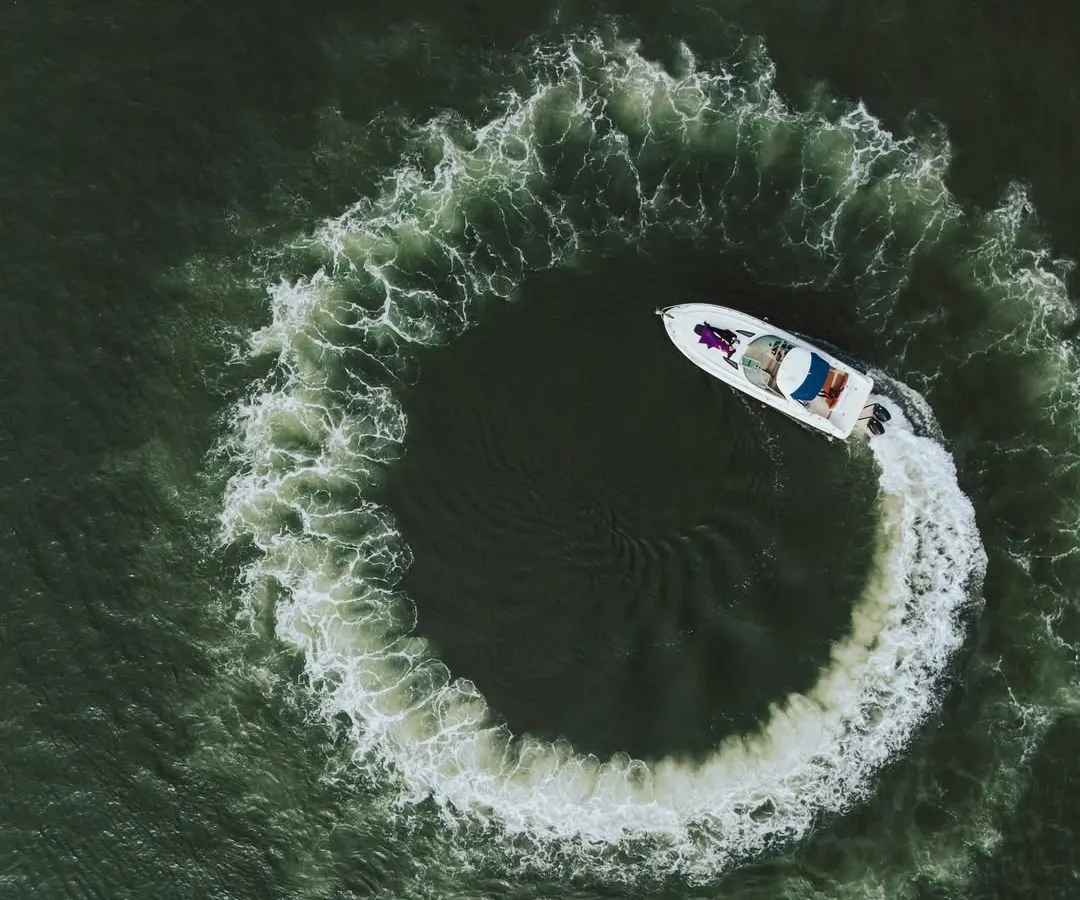 This aerial drone shot captures a luxury yacht carving a perfect circle in the water. It’s a unique and cinematic perspective that I bring to destination pre-wedding shoots, adding a touch of adventure and grandeur.