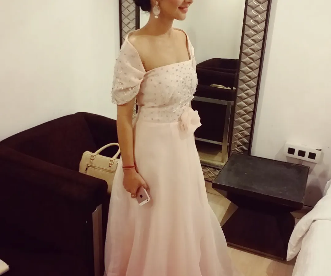 This light pink off-shoulder gown is one of my signature pieces, perfect for a roka, engagement, or cocktail party. The design features a flowing organza skirt and a bodice covered in delicate hand embroidery with pearls and sequins for a touch of glamour.