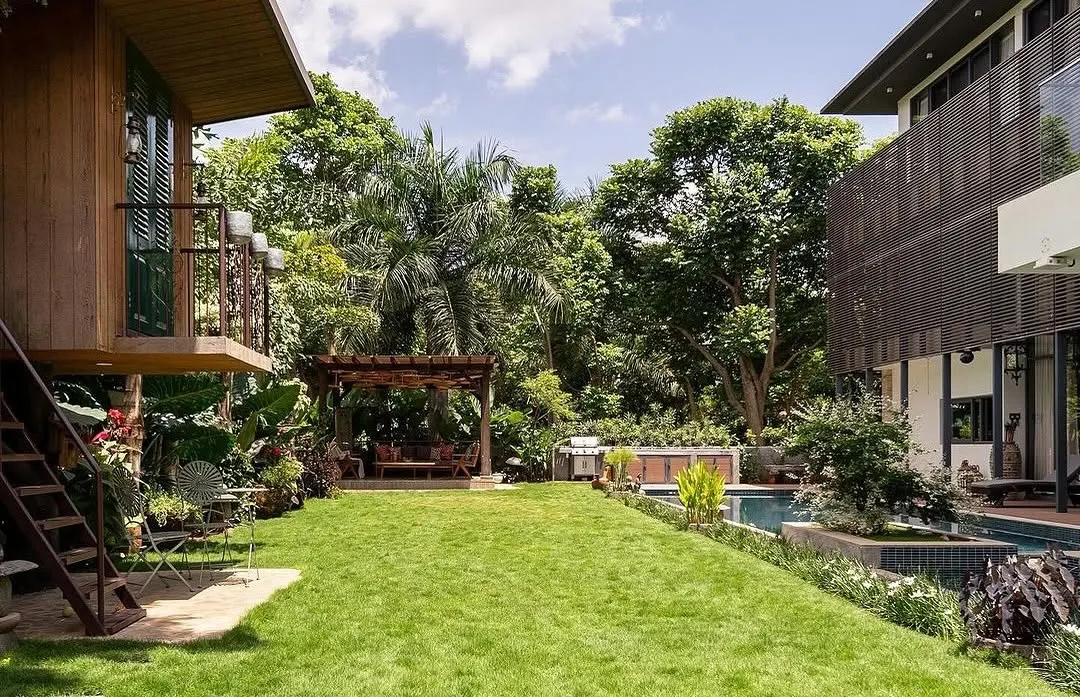 For this expansive villa at Embassy Boulevard, I designed a tropical paradise featuring a vast lawn, a serene poolside, and a custom gazebo, creating a seamless connection between the home and its natural surroundings.