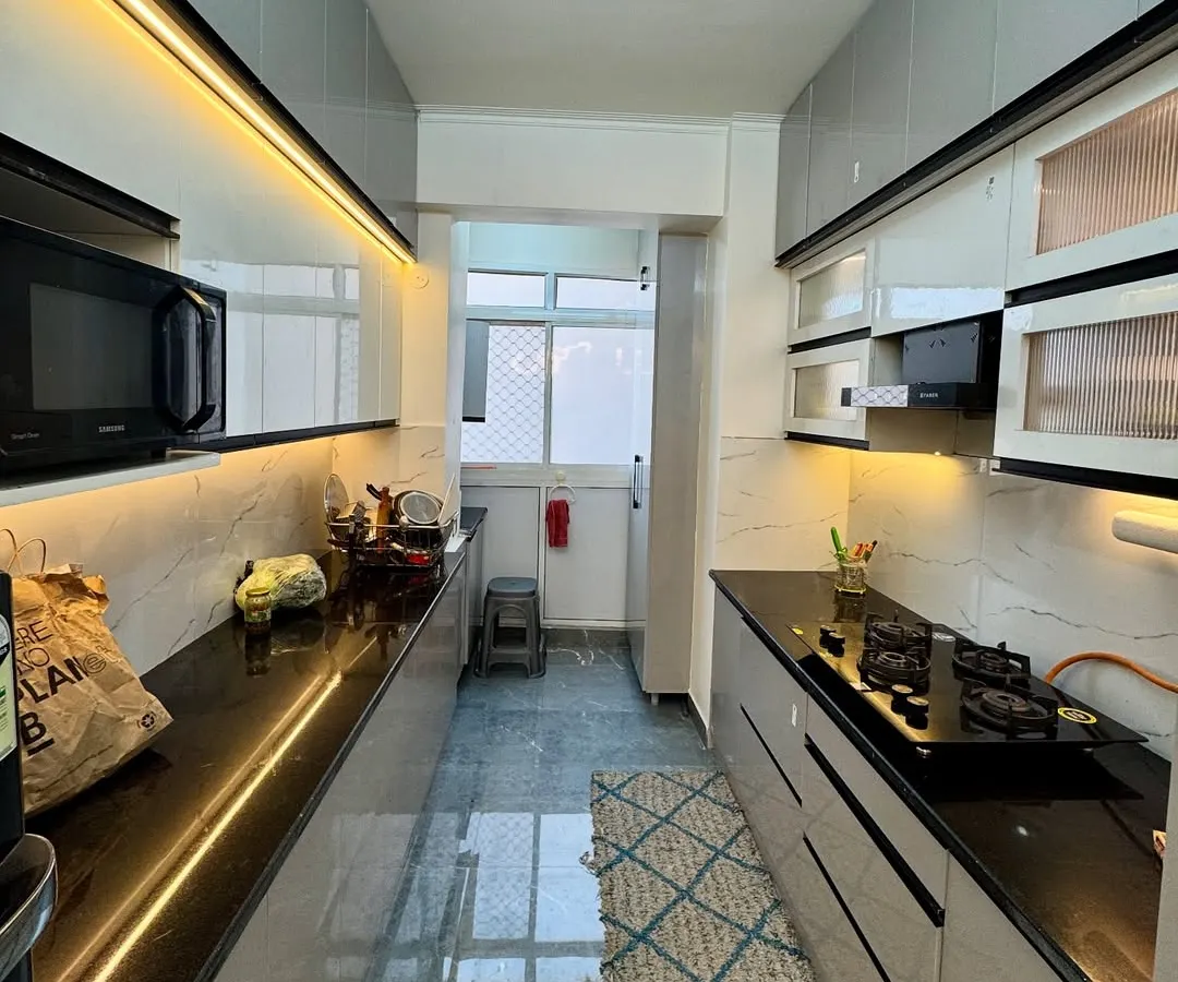 A look at a completed parallel kitchen in Amrapali Princly Estate. I focused on maximizing counter space and storage, using under cabinet LED lighting to create a bright and functional cooking environment.