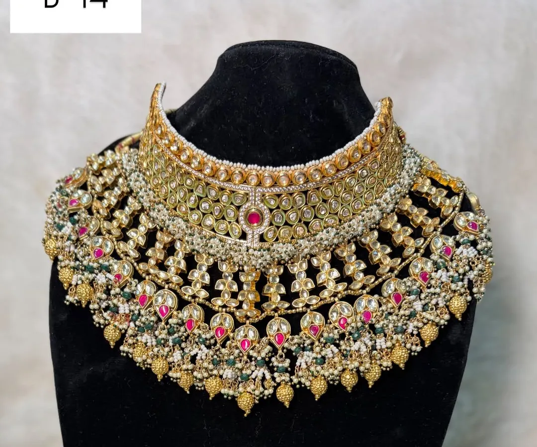 For the bride who wants ultimate grandeur, this is my B-14 heavy bridal rental set. It features intricate kundan and polki work with touches of red and green, designed to make a breathtaking statement.