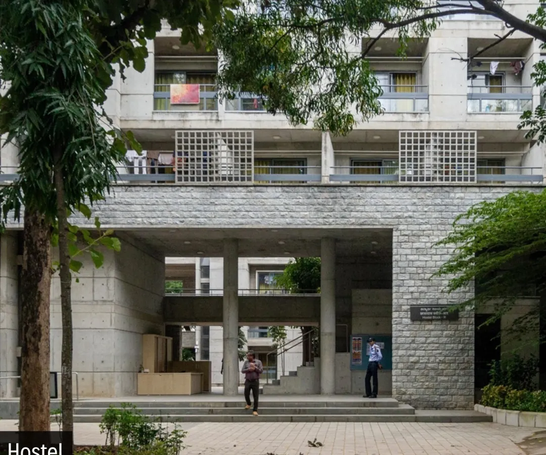 The entrance to the new hostel at IIM Bangalore, completed in 2022. We designed this entrance to be porous and inviting, using a blend of the campus's signature stone with modern exposed concrete to create a structure that respects its legacy while asserting its own identity.