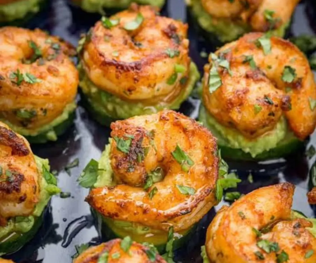 A close-up of our perfectly seared sriracha prawns served on a bed of fresh avocado. Each appetizer is a testament to our commitment to flavor and presentation, designed to be a memorable single bite.