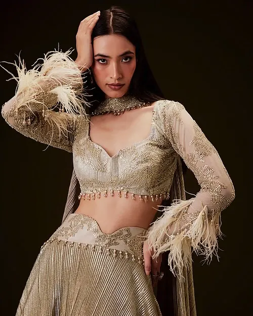 For this ethnic wear campaign, I created a soft glam makeup look with a defined eye and a clean, elegant hairstyle. The goal was to enhance the model's features without overpowering the intricate details of the feathered lehenga.
