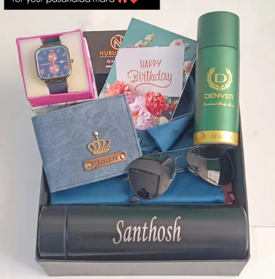I love putting together these complete gift hampers. This one includes a personalized denim wallet, a name-engraved temperature bottle, a watch, sunglasses, and a men's deodorant, all beautifully arranged for a special birthday surprise.