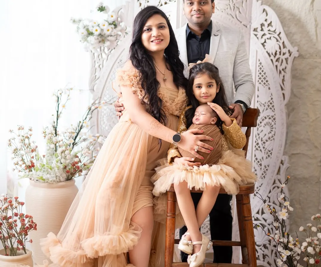 A newborn session is a celebration for the whole family. I captured this beautiful family of four, with the proud big sister holding her new baby sibling, creating a complete and heartwarming first family portrait.