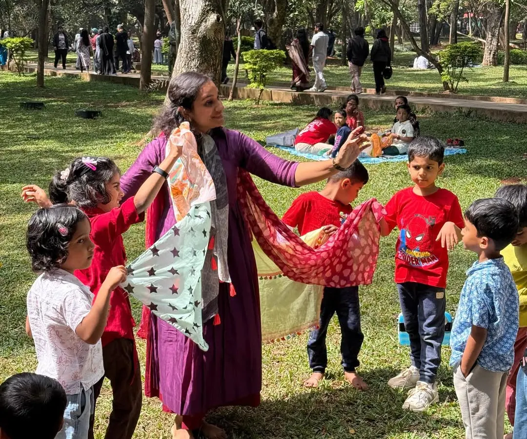 It's not just about listening, it's about feeling the story! Here, we're using colorful scarves to dance and express ourselves, bringing the narrative to life through movement. This kind of sensory play is a core part of our immersive workshops in Cubbon Park.