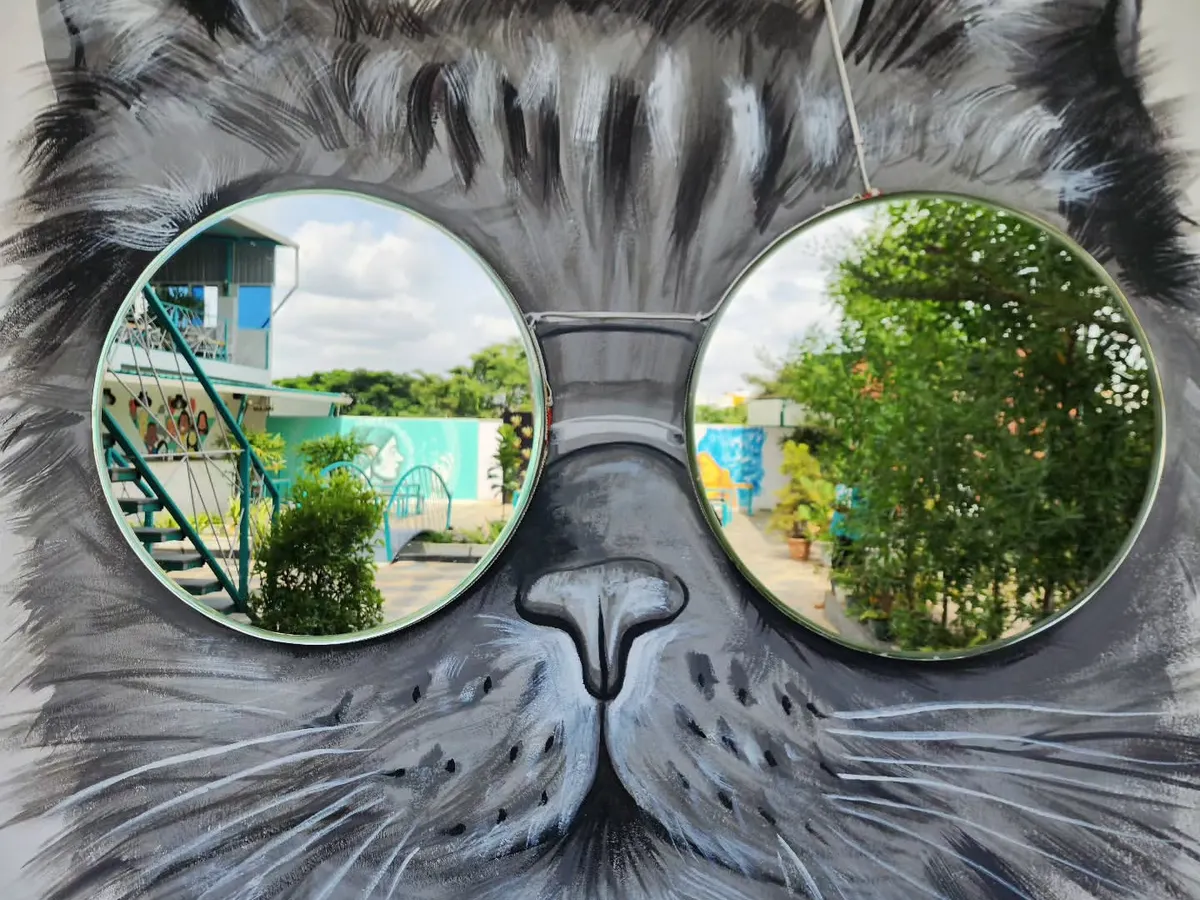 We love making art you can interact with. For this project, we painted a cool cat mural and integrated two circular mirrors as reflective sunglasses, creating a functional and playful piece for a commercial space.