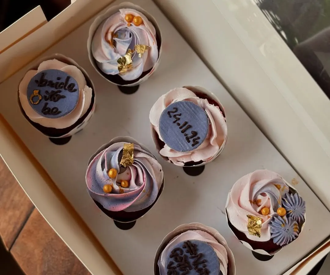 A beautiful set of cupcakes for a bridal shower. I used a mix of delicate frosting swirls, edible gold leaf, and custom fondant plaques with the wedding date to create an elegant look.