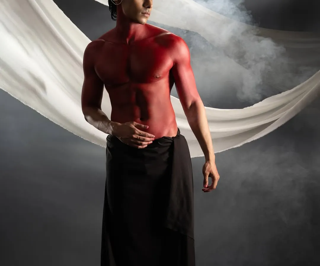Body painting is a powerful way to tell a story. For this conceptual shoot, I used bold red body paint to create a striking, mythological character, sculpting with color and shadow.