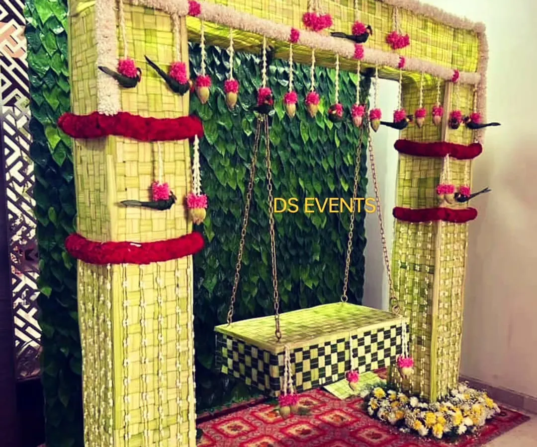 For a beautiful and eco-friendly naming ceremony, I designed this swing and backdrop entirely from woven coconut leaves. It’s a testament to how traditional materials can create stunning, sustainable decor.