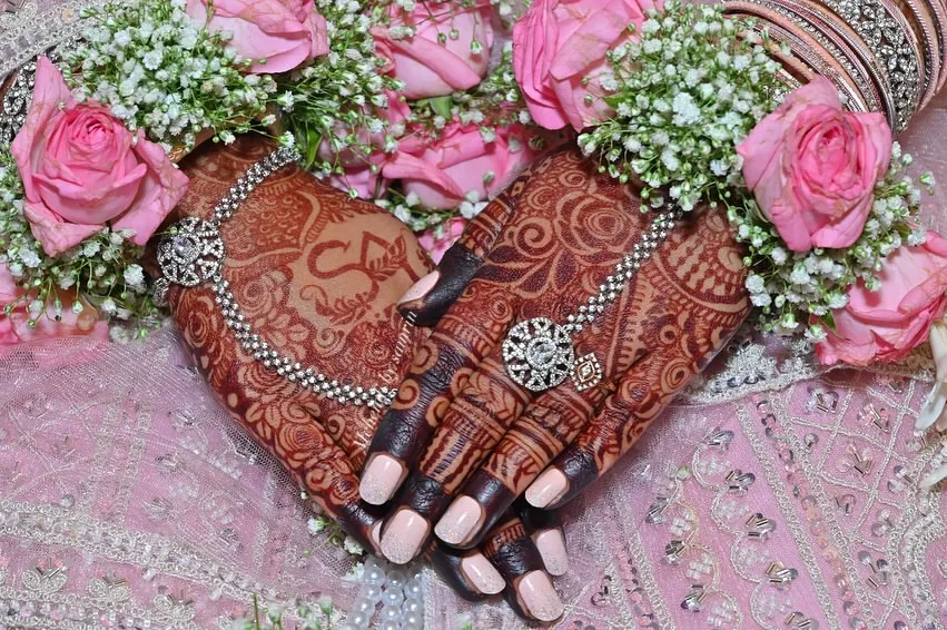 This is the result I live for. A gorgeous, deep henna stain on my bride's hands, perfectly complemented by her floral jewelry. I use only organic henna to ensure you get this rich, beautiful color for your special day.