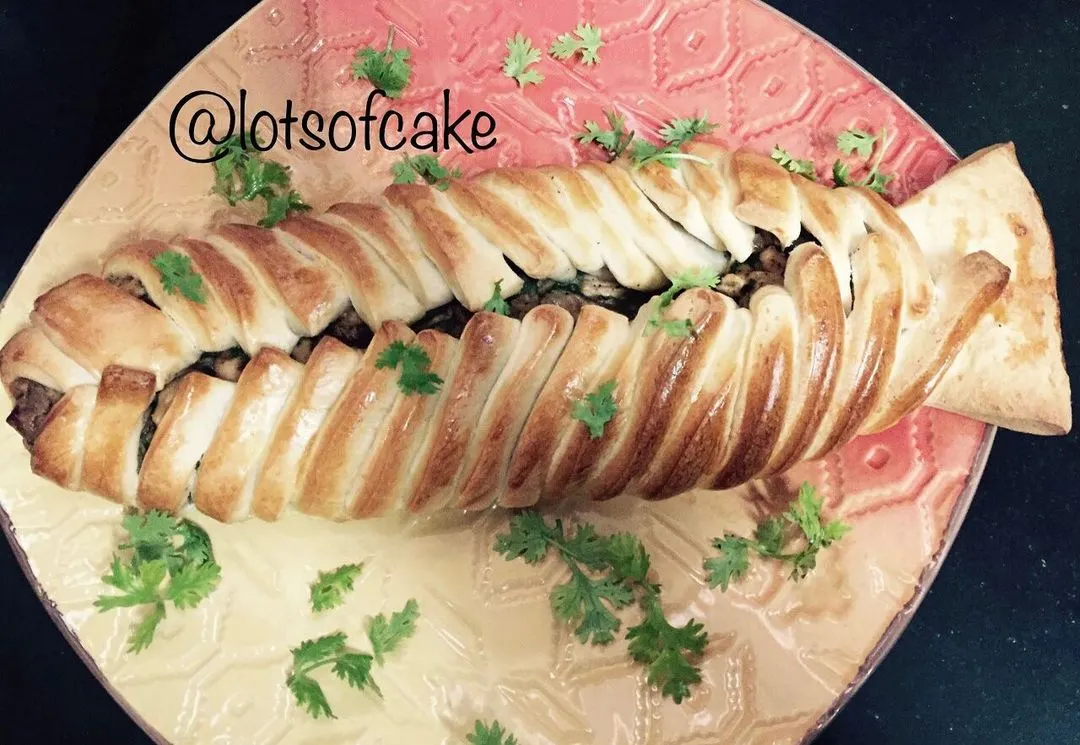 Who says pizza has to be round? This is my braided chicken pizza, stuffed with seasoned chicken and herbs. It's a real showstopper on the table and tastes just as amazing as it looks.