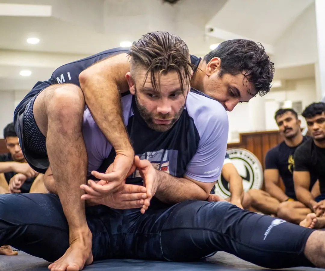 The devil is in the details. Here, BJJ black belt Mike Murrell demonstrates the precise hand-fighting and control needed to secure a seatbelt grip, a fundamental position in submission wrestling and MMA.