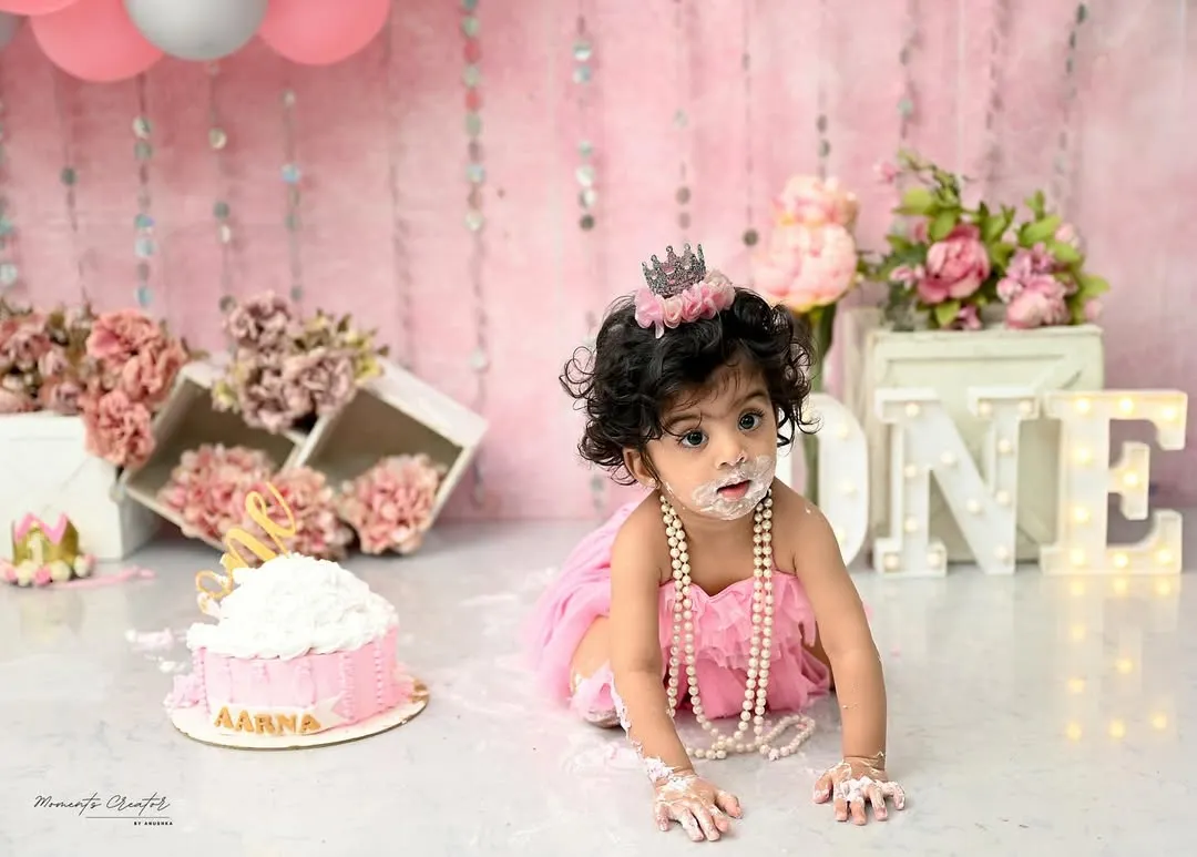 The pure, messy joy of a first birthday cake smash! This little princess is having the time of her life exploring her first taste of cake. These sessions are all about capturing candid happiness and personality.