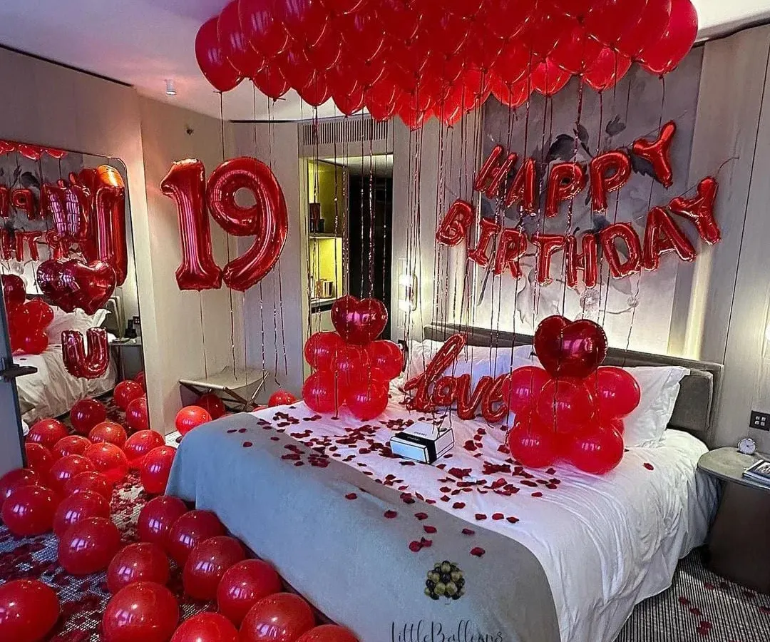 A classic for a reason. This romantic birthday room makeover features a sea of red balloons, rose petals, and bold foil letters to make your loved one feel truly special. It's a full sensory experience of love and celebration.