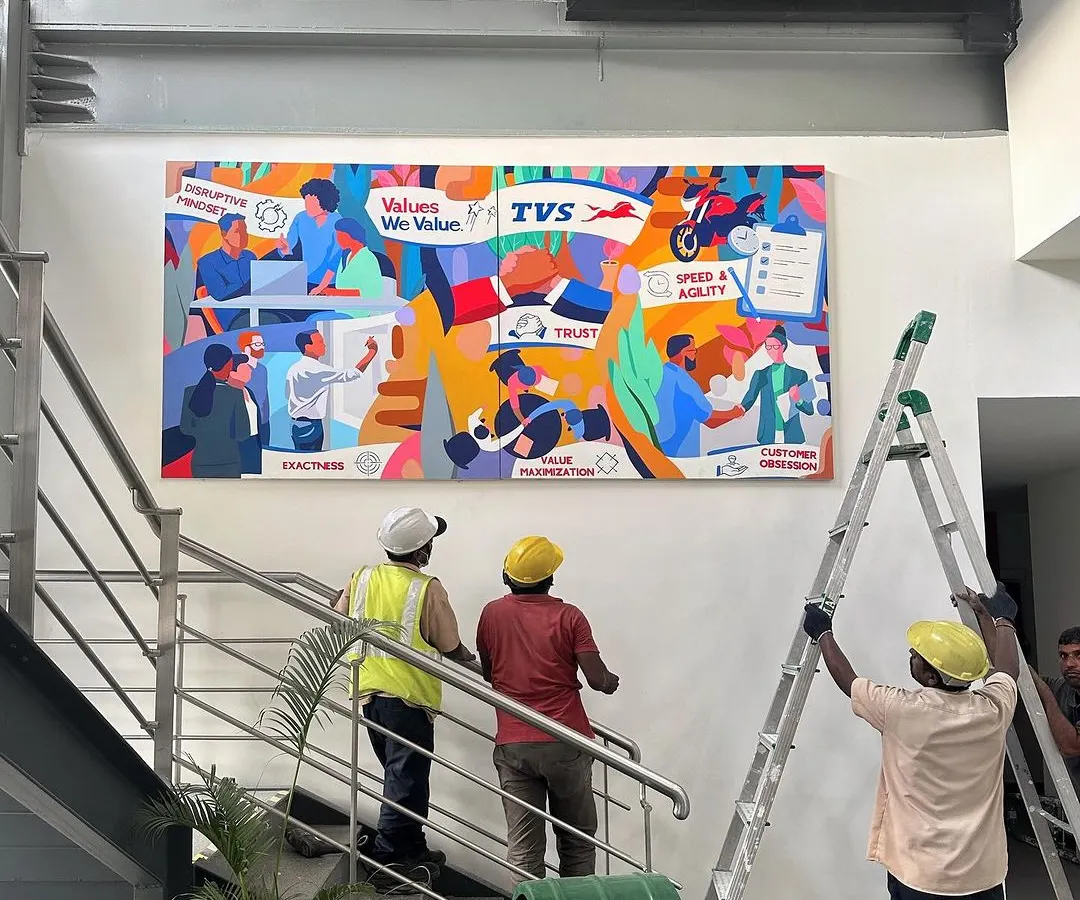 Here is the final mural installed at the TVS Motor Company office. This large-scale artwork serves as a permanent and powerful reminder of the team's shared values, transforming a simple staircase into a gallery of corporate identity and pride.