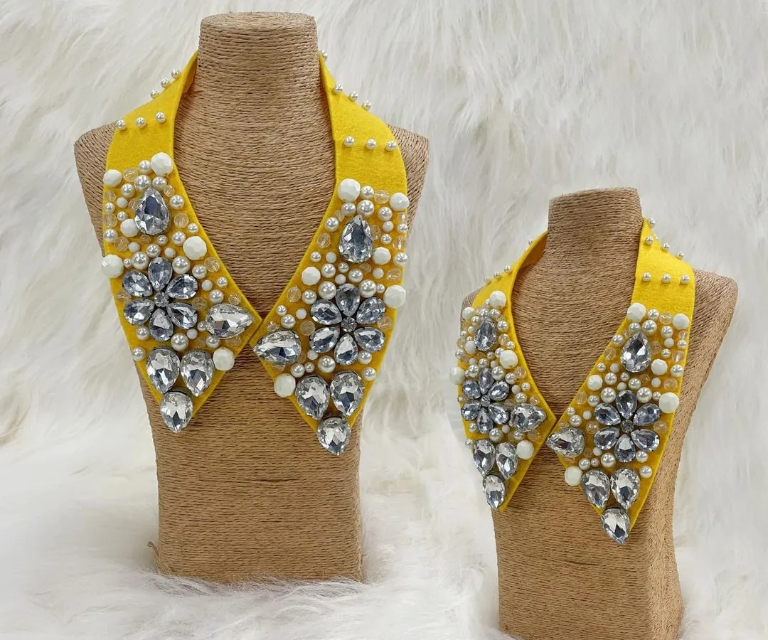 Instantly transform any outfit with our detachable statement collars. This piece, shown in both adult and child sizes, features a vibrant yellow base adorned with large faceted crystals and delicate pearls for a truly glamorous look.