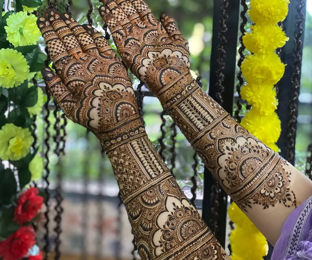 A full bridal design, created with love and dua. Every line, from the delicate paisleys to the fine checks, is drawn to celebrate your unique story. This is a classic intricate Indian bridal henna, covering the arms for a complete look.