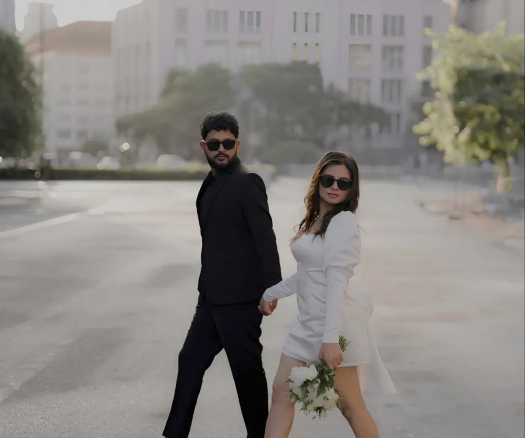 There is a certain magic to an empty city street at dawn. For this shoot, we embraced a modern, chic aesthetic, creating images that feel like stills from a contemporary film. The contrast of their black and white outfits against the urban architecture tells a story of confident, stylish love.