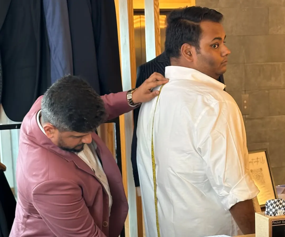 The foundation of a bespoke garment is a perfect fit. Here, our founder Ujjwal Savla takes precise measurements, considering not just size but posture and individual body shape to ensure the final shirt drapes flawlessly. This is the first step in crafting a garment that feels like a second skin.