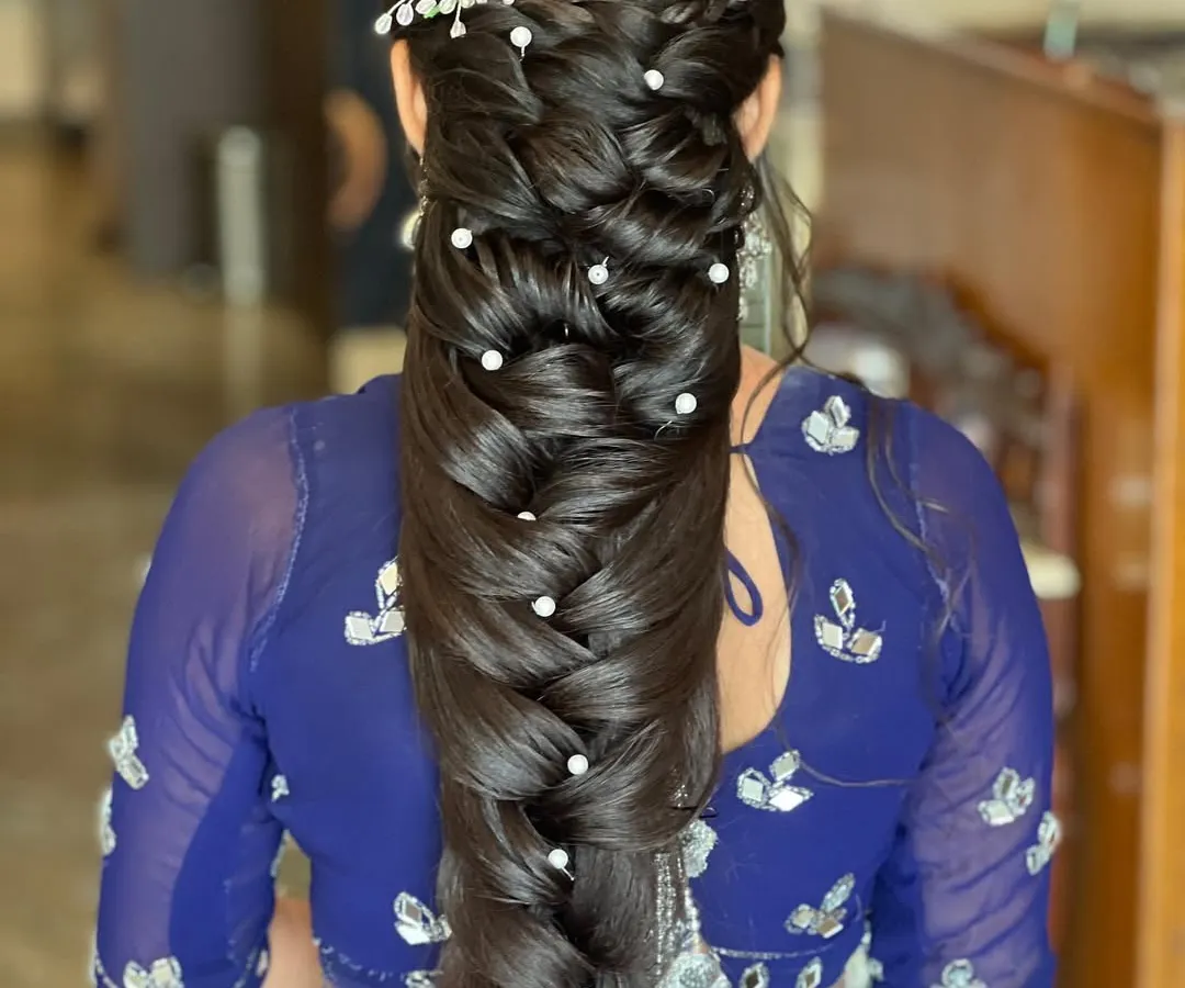 The mermaid braid is a style I absolutely love creating. This look features a thick, multi-layered braid, detailed with small pearls throughout for a touch of elegance, and finished with a sparkling hair accessory.