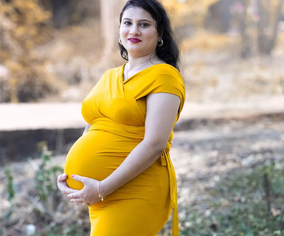 My photography style often uses the warm, golden glow of natural light to create soft and intimate portraits. This medium shot focuses on the mother's happy expression, capturing a quiet moment of connection in a beautiful, naturally lit setting.