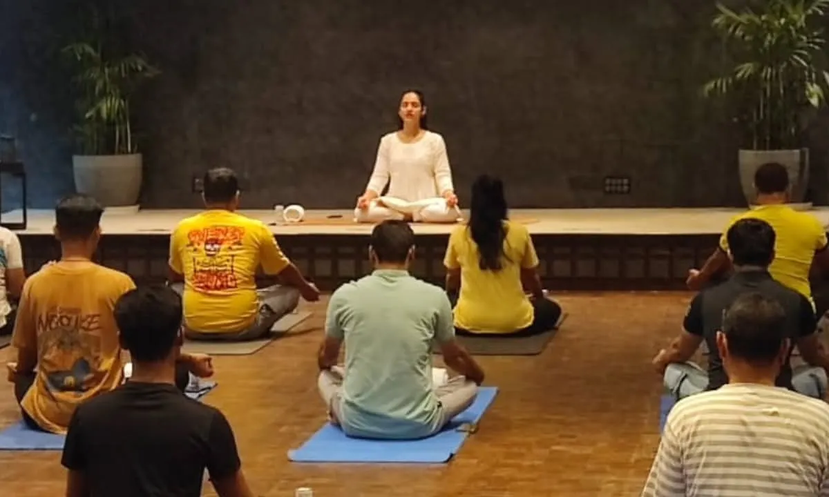 I guide a corporate group through a calming meditation session. My goal in these office wellness programs is to create a peaceful space for employees to disconnect from stress and reconnect with their inner calm, improving focus and well being.