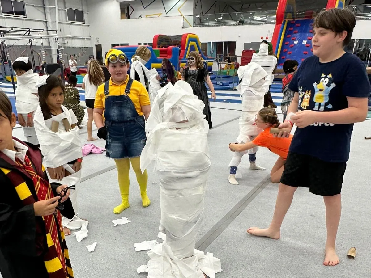It's a wrap! Our "Make-A-Mummy" contest during a Halloween-themed Friday Fun Night is just one example of the creative and hilarious games we organize to keep every kid engaged and laughing.