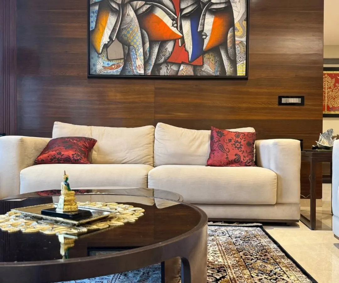 We believe art should not just hang on a wall, it should live in the space. This abstract figurative work by Jagannath Paul, 'Togetherness', brings warmth, emotion, and a modern aesthetic to our client's living room, perfectly complementing the rich wooden textures and creating a focal point for conversation.