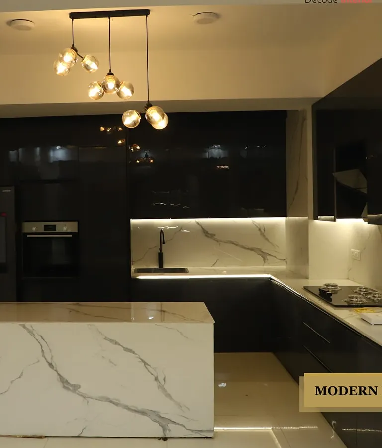 This is a modern kitchen I designed for a client who loves bold contrasts. It features sleek, black high-gloss cabinetry paired with a striking white marble-patterned island and backsplash, all illuminated by statement pendant lighting and under-cabinet LEDs.