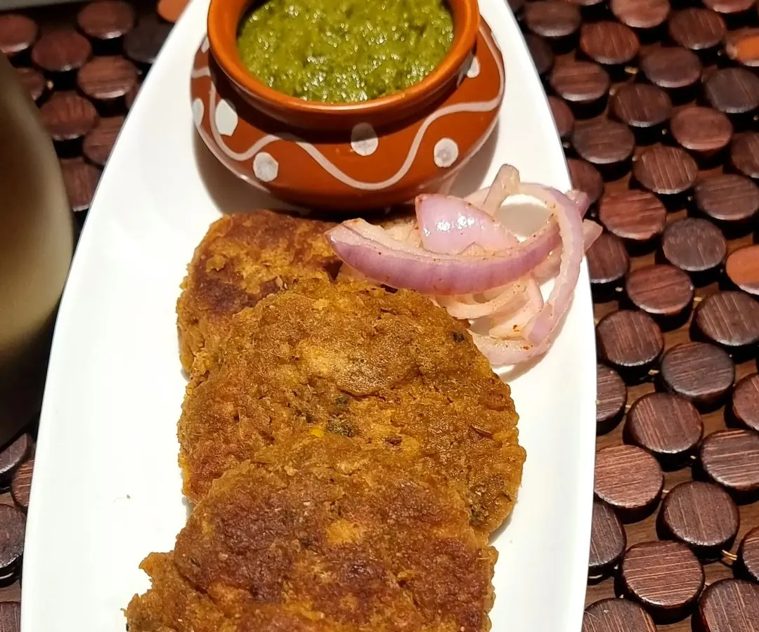 These are my special Yam Kebabs, served with fresh mint chutney and onion rings. They are crispy on the outside and wonderfully soft inside, made with a blend of spices that I've perfected over the years.