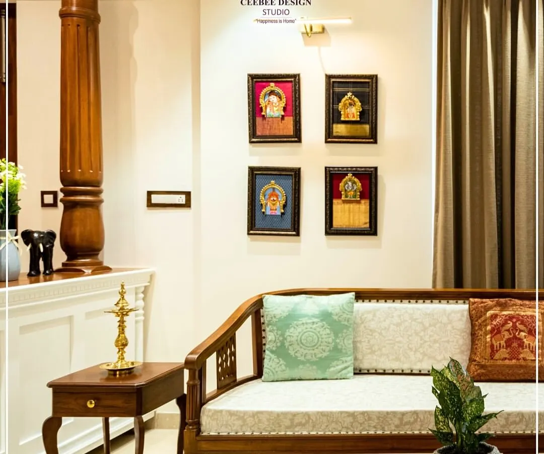 I believe a home should be a canvas for our cultural legacy. This living room is inspired by the timeless elegance of Kerala's architecture, featuring a traditional carved wooden sofa, a stately pillar, and a curated gallery of Tanjore paintings. It’s a space that feels both luxurious and deeply rooted in Indian heritage.