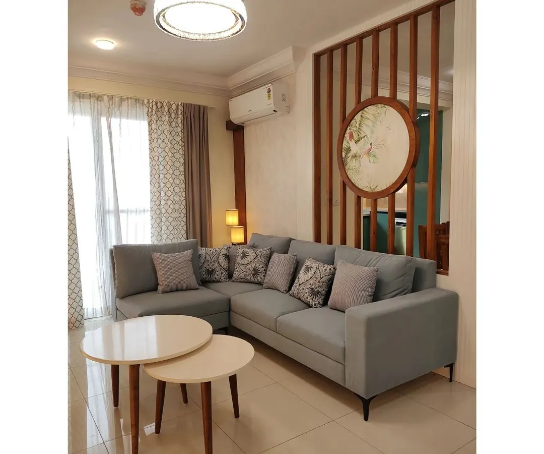 I believe a living room should be a quiet promise of comfort and elegance. Here, a custom L-shaped sofa, nesting tables, and a unique slatted partition with delicate artwork come together to create a space for conversations, dreams, and cherished moments.