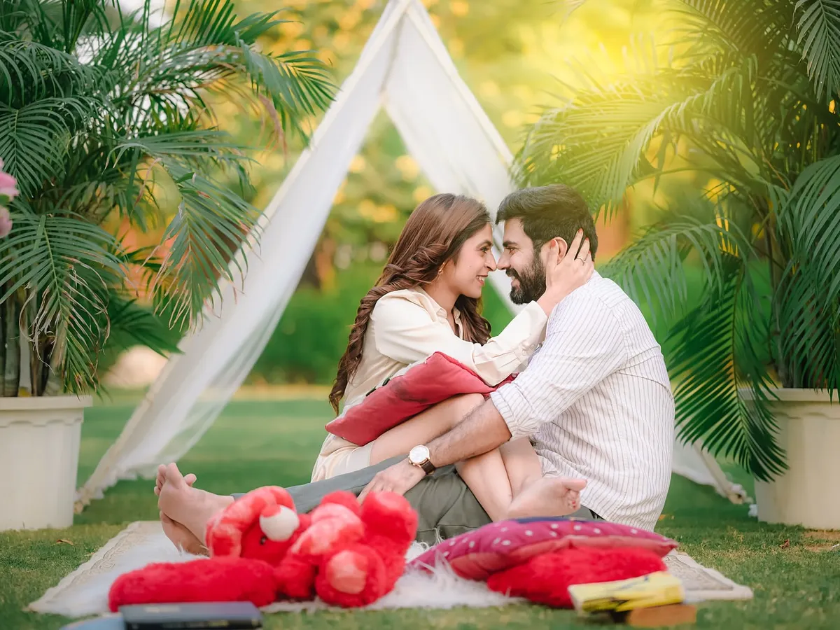 An intimate moment from a romantic picnic setup in our lush garden. This scene, complete with a decorative tent and plush cushions, is perfect for capturing candid and cozy couple portraits.