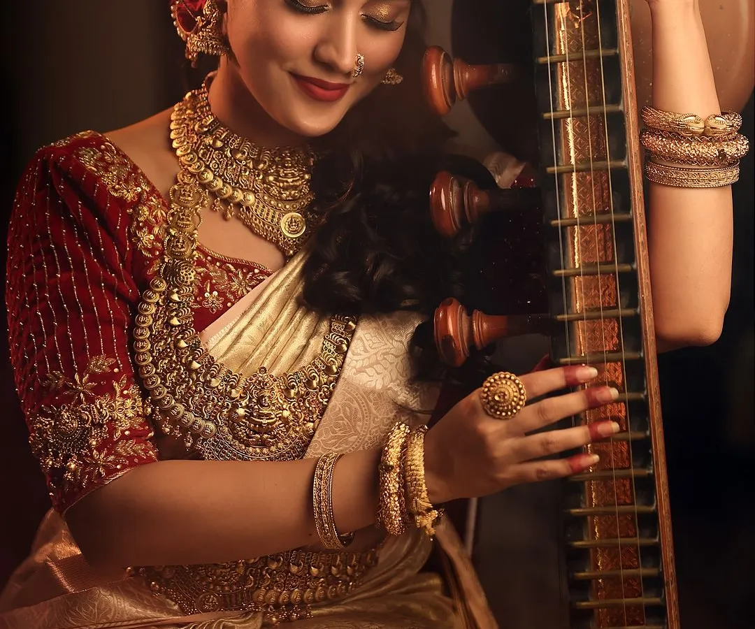 The quiet moments are often the most profound. Here, I focused on the bride's connection with the veena, using soft, warm lighting to highlight the intricate gold jewelry and the rich textures of her silk saree, creating an image filled with cultural grace.