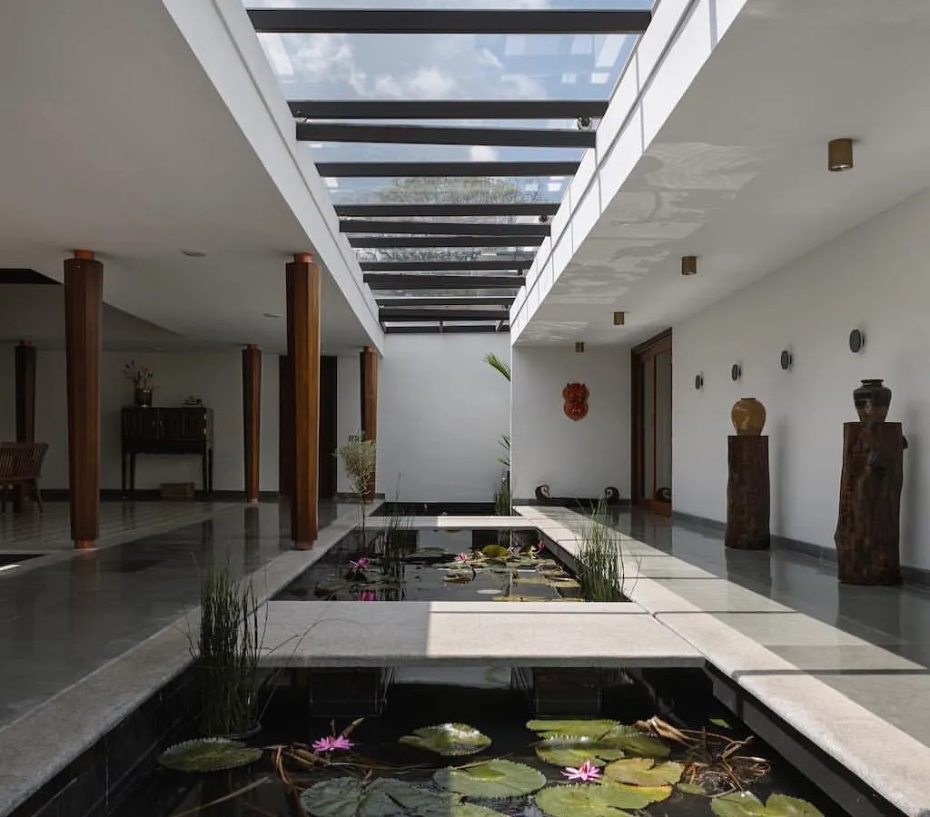 We feature spaces that bring the outdoors in. This home in Kottayam by Thomas Parambil Architects dissolves the boundaries between interior and landscape with a serene, sky-lit water court filled with lilies, creating a tranquil heart for the home.
