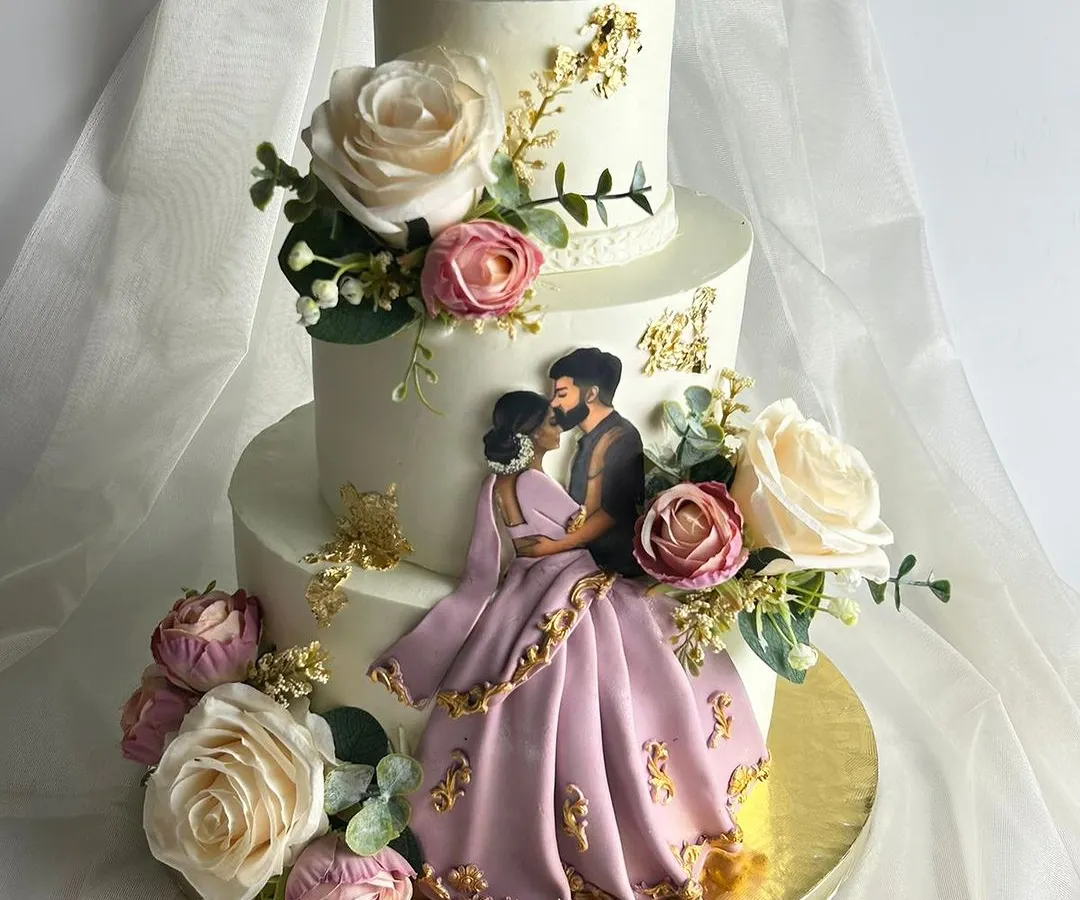 This three-tier masterpiece was for a beautiful Valima ceremony. The couple wanted their outfits and love story reflected in the design, so I handcrafted this edible illustration of them, surrounded by delicate sugar flowers matching the bride's sari. It’s these personal touches that turn a cake into a cherished part of the celebration.