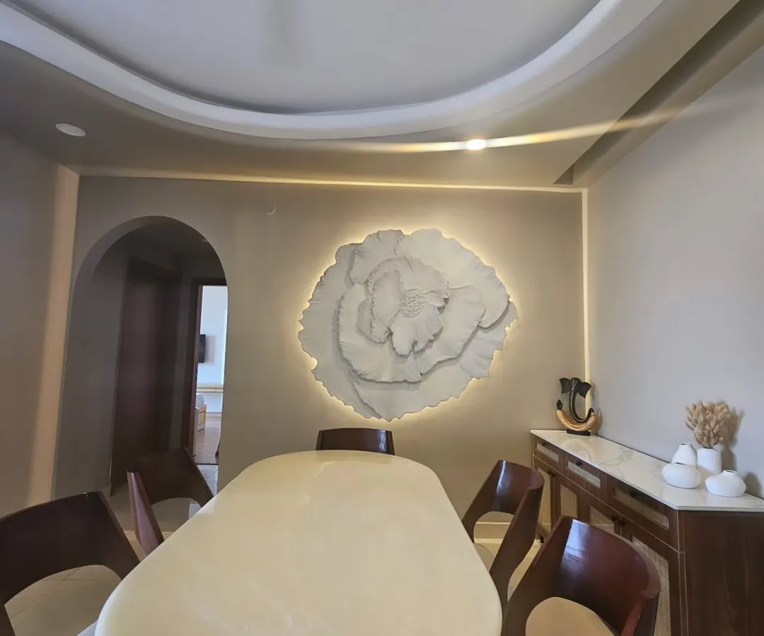 This large scale 3D floral installation became the heart of our client's dining room. Weighing over 40 kgs, this textured wall art piece shows how we can transform a simple wall into a dramatic and elegant statement, complete with custom backlighting.