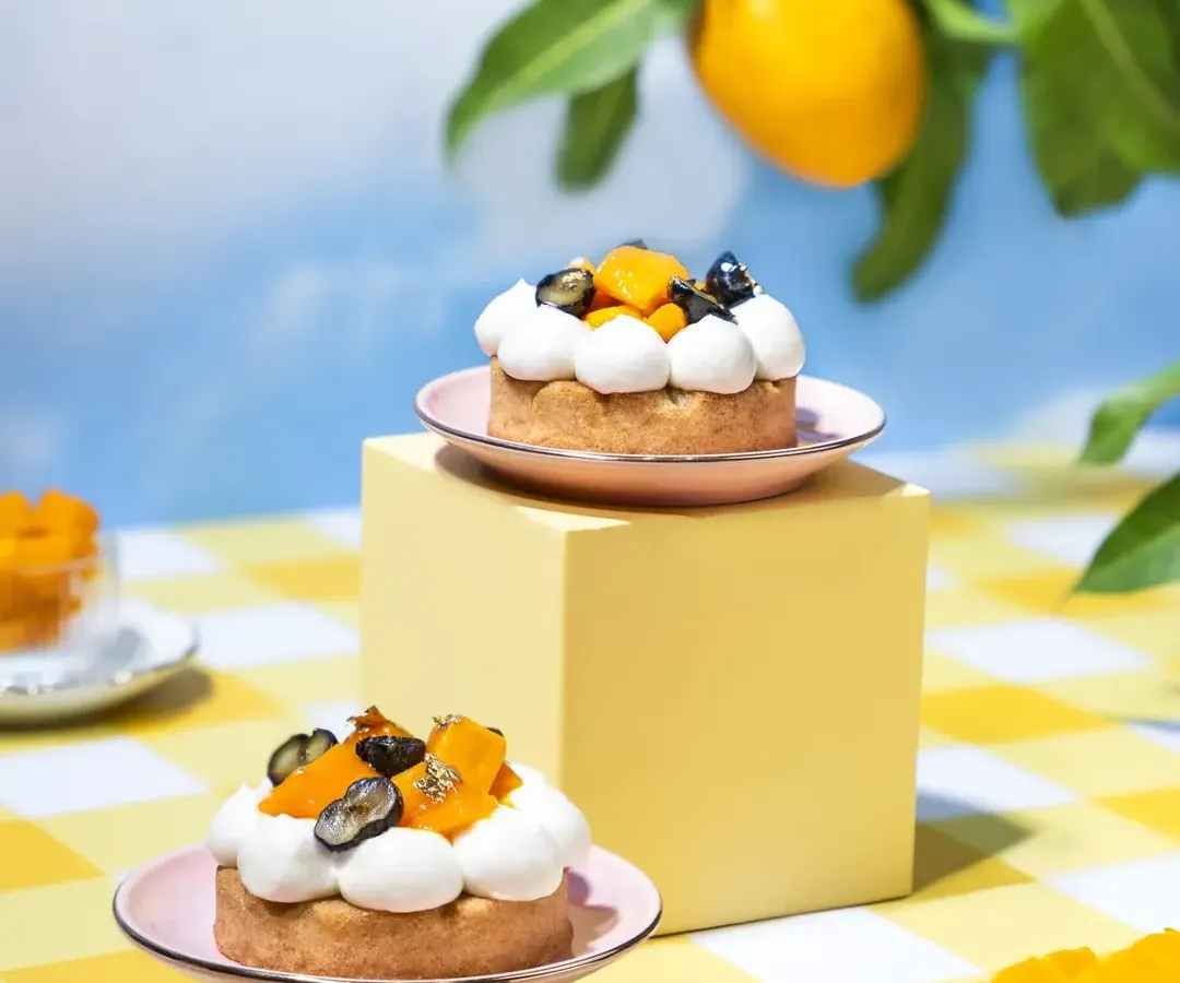 We created this whimsical summer picnic to celebrate the magic of mango season. This shot is from a concept we designed from the ground up, using a surreal outdoor setting with bright, airy tones and minimal props to let the beautiful mango desserts be the hero.