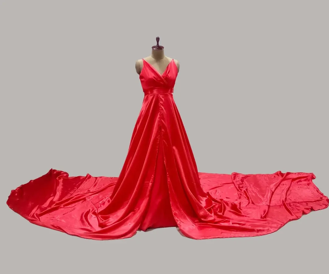 This is our classic red satin maternity gown, designed with an extra-long trail. It is the ideal choice for creating dramatic 'flying gown' effects in your outdoor photoshoots.