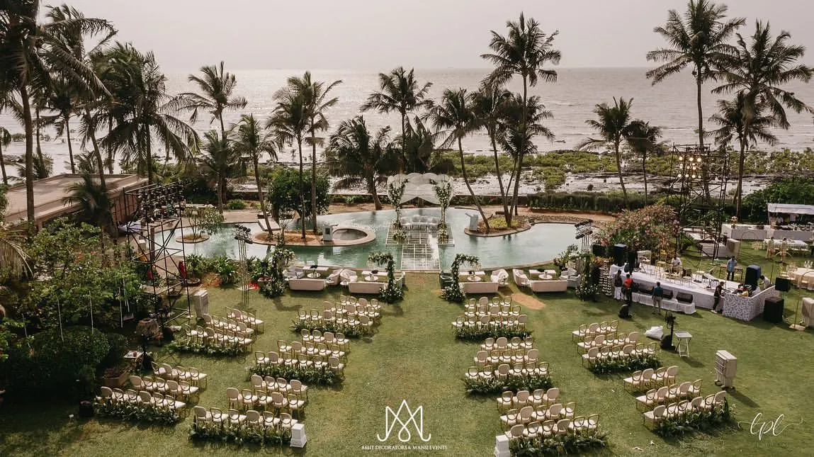 I love crafting breathtaking outdoor weddings. Here, I designed an elegant seaside ceremony with a stunning mandap built over the pool, creating a serene and luxurious atmosphere against the ocean backdrop.